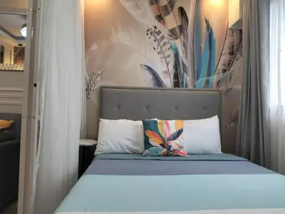 a bed with a headboard in a bedroom at POSH 1 BR Unit+ Netflix*WIFI @ Shore 2 in Manila