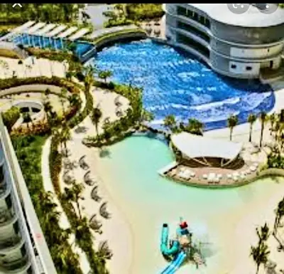 a view of a pool at a resort at Azure Condo 1BR Next to Mall, Near City & Airport in Manila