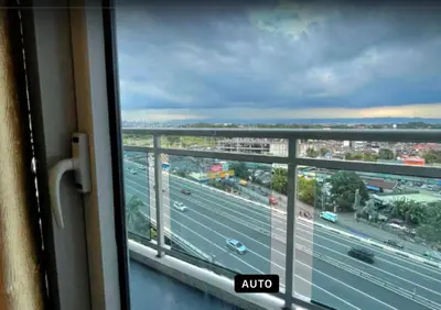 a view of a highway from a window in a train at Azure Condo 1BR Next to Mall, Near City & Airport in Manila