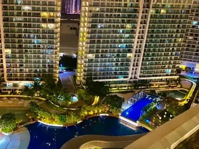 arial view of a large building with a pool of water at Azure Condo 1BR Next to Mall, Near City & Airport in Manila