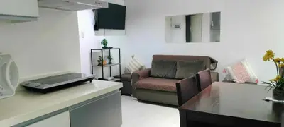 a living room with a couch and a chair at Staycation at Azure Urban Resorts in Manila