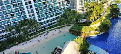 an aerial view of a resort with a beach and buildings at Staycation at Azure Urban Resorts in Manila