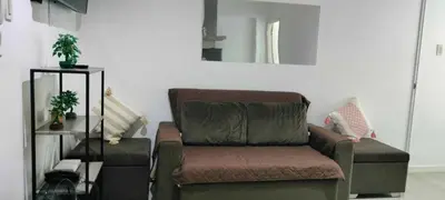 a living room with a couch and a mirror at Staycation at Azure Urban Resorts in Manila
