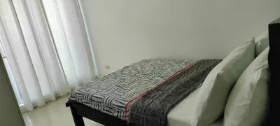a bed with a blanket on it in a bedroom at Staycation at Azure Urban Resorts in Manila