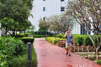 a man walking down a path in a park at Great View in Makati in Manila