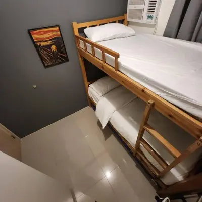 a bunk bed in a room with a picture on the wall at Homey 2br apartment in Makati in Manila