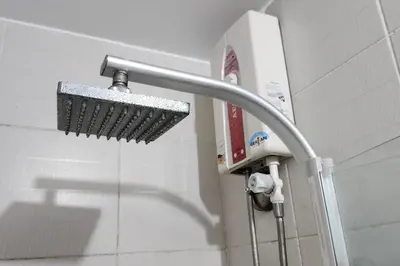 a shower head on a wall in a bathroom at Homey 2br apartment in Makati in Manila