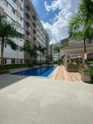 a swimming pool in the middle of a building at Studio Type Condominum at SMDC HOPE Residences in Trece Martires