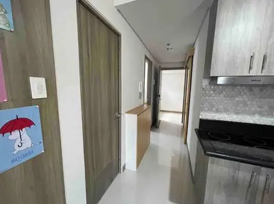 a small room with a kitchen with a door with an umbrella sign at Coast of Finland: Stunning Manila Bay & Sunset in Manila