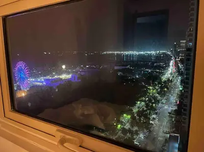 a view of a city at night from a window at Coast of Finland: Stunning Manila Bay & Sunset in Manila