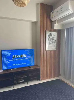 a living room with a flat screen tv on a wall at Coast of Finland: Stunning Manila Bay & Sunset in Manila