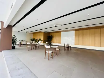 a large room with tables and chairs in a building at Amiela’s Place in Trece Martires