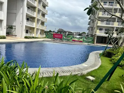 a swimming pool in front of two apartment buildings at The Atherton in Manila