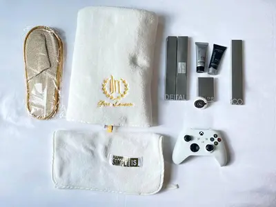 a table with a white towel and a game controller at Thompson Suites - 2 beds, One Uptown Residences 28F A - XBOX & Netflix in Manila