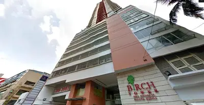 a building with a clock tower on top of it at Birch Tower a2 Front of Robinson Mall in Manila