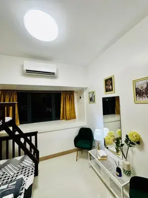 a living room with a bed and a window at Makati Staycation by Marco - SMDC Lush in Manila