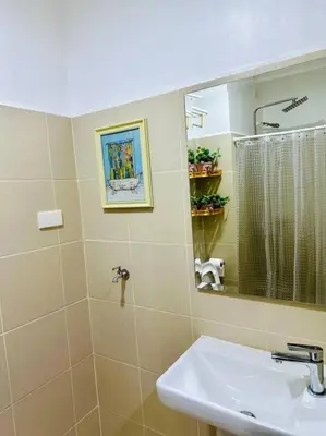 a bathroom with a sink and a mirror at Makati Staycation by Marco - SMDC Lush in Manila