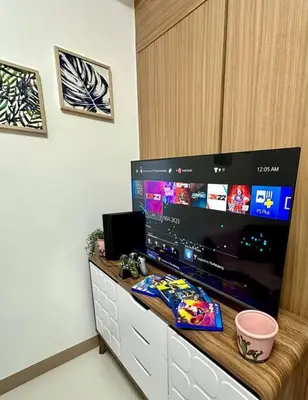 a large flat screen tv sitting on top of a counter at Makati Staycation by Marco - SMDC Lush in Manila