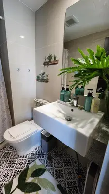 a bathroom with a white sink and a toilet at Le Palis Suite in Bukal