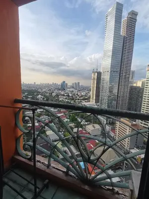 a view of the city from the balcony of a building at citadel inn apartment in Manila
