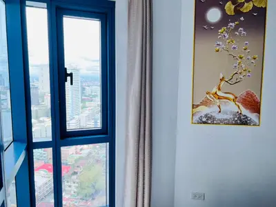 a room with a window with a picture of a tree at Dreamy Sunset Bay in Manila
