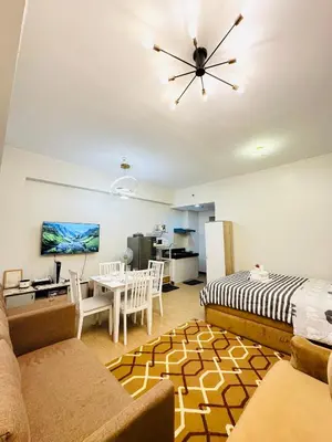a living room with a couch and a table at Starlight Suites in Trece Martires