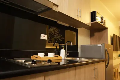 a kitchen with a sink and a counter top at Homefort at Shore Residences in Manila