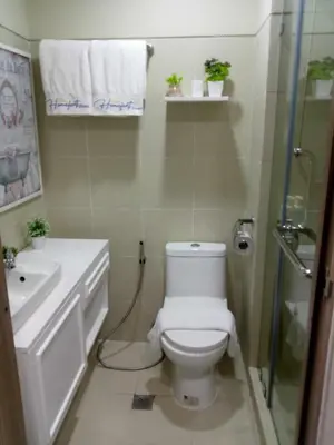 a bathroom with a toilet and a sink and a shower at Homefort at S Residences in Manila