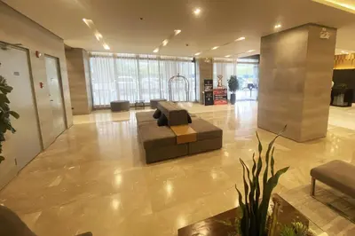 a lobby with a couch in the middle of a building at Homefort at S Residences in Manila