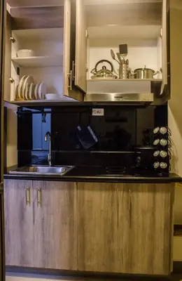 a kitchen with a sink and a microwave at RQ Cozy One Bedroom Condo, Coast Residences Pasay in Manila