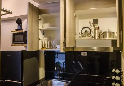 a kitchen with a sink and a microwave at RQ Cozy One Bedroom Condo, Coast Residences Pasay in Manila