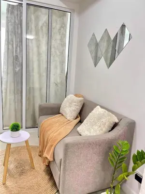 a living room with a couch and a table at A3J Staycation at Azure Urban Resort Residences in Manila
