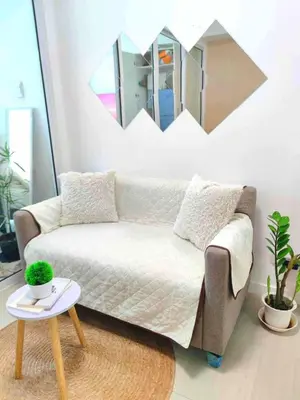 a living room with a couch and a mirror at A3J Staycation at Azure Urban Resort Residences in Manila