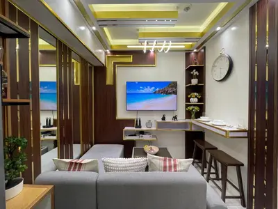 a living room with a couch and a table at SMDC Coast Residences in Manila