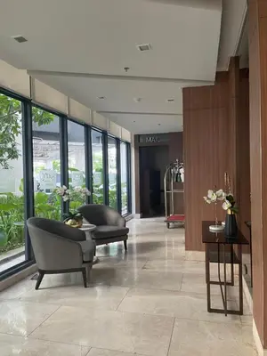 a lobby with a waiting area with furniture and windows at Hope Serenity, Spring Residences Tower 3 in Manila