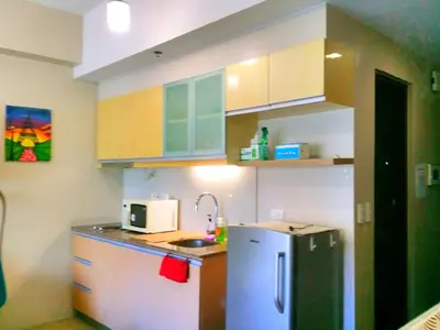 a small kitchen with a sink and a refrigerator at Studio-Type Condo at Eastwood Legrand 3 in Manila