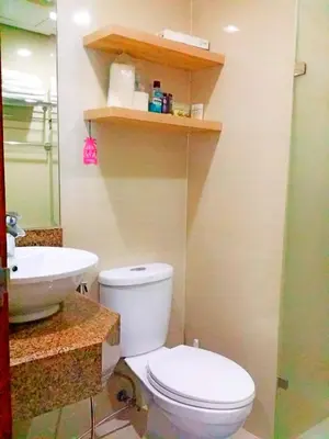 a bathroom with a white toilet and a sink at Studio-Type Condo at Eastwood Legrand 3 in Manila