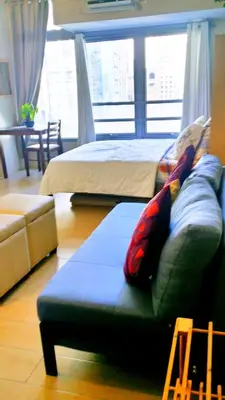a living room with a couch and a bed at Studio-Type Condo at Eastwood Legrand 3 in Manila