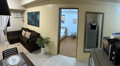 a living room with a couch and a table at The Beacon Makati in Manila