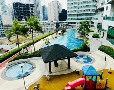 a view of a playground with a pool in a city at The Beacon Makati in Manila