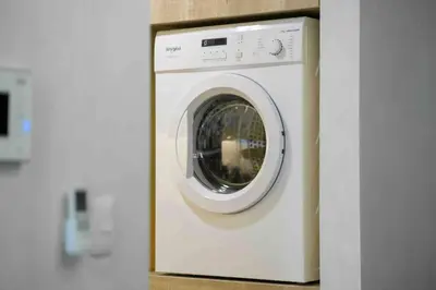 a white washing machine sitting in a kitchen at 1 BR with balcony in Uptown BGC in Manila