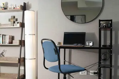 a desk with a blue chair and a computer at Cozy 1BR with Balcony and Netflix in Uptown BGC in Manila