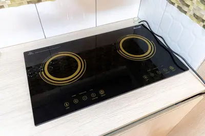 a black appliance with gold handles on a counter at A2J BGC Luxury 2BR Loft Near High Street, Airport in Manila