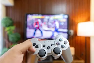 a person holding a video game controller in front of a tv at A2J BGC Luxury 2BR Loft Near High Street, Airport in Manila