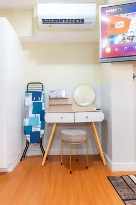 a room with a desk with a chair and a tv at A2J BGC Luxury 2BR Loft Near High Street, Airport in Manila