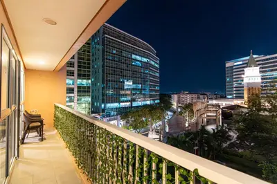 a balcony with a view of the city at night at Luxury Condo at Venice Mall near Airport, BGC & Makati in Manila