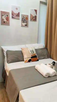 a bed with pillows on it in a room at Anuva Stays in Manila