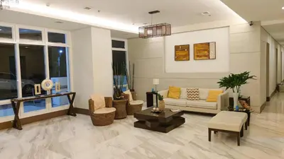 a living room with a couch and a table at Anuva Stays in Manila