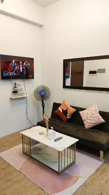 a living room with a couch and a coffee table at Anuva Stays in Manila