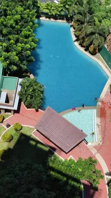 an overhead view of a large swimming pool with trees at Anuva Stays in Manila